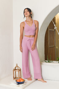 Model wearing pink knit top and knit pants 