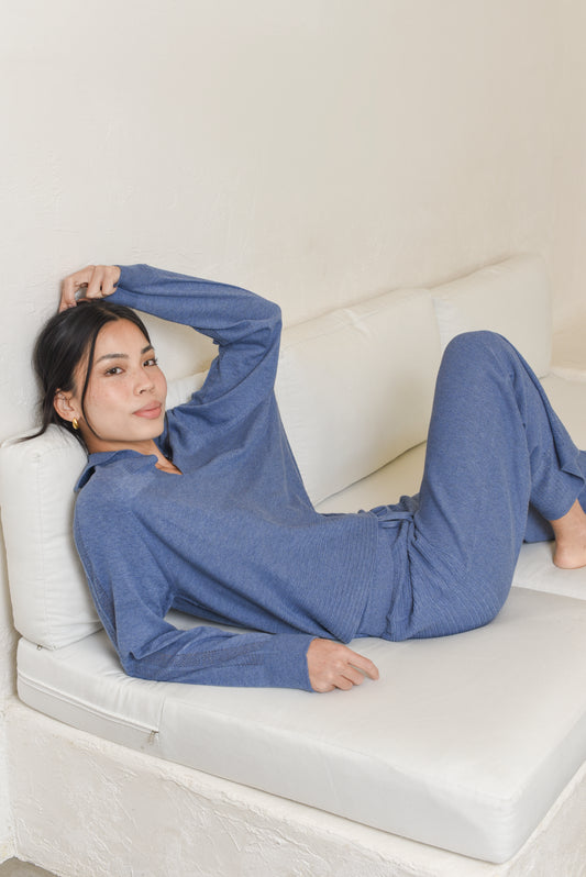 Model wearing blue knit polo pullover with matching pants