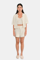 Model wearing cropped shirt in Starch with matching tank and shorts 