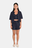 Total look of model wearing cropped shirt in Deep Navy with matching tank and shorts