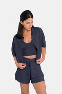 Model wearing cropped shirt in Deep Navy  with matching tank and shorts