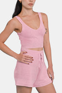 Side view of model wearing cropped tank in Sheer Pink with matching shorts
