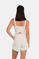 Back view of model wearing cropped tank in Starch with matching shorts 