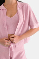 Close up of model wearing cropped shirt in Sheer Pink 